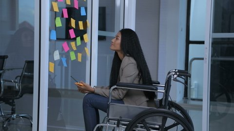 Business concepts. The disabled girl is writing an attitude to comment on the office. 4k Resolution.