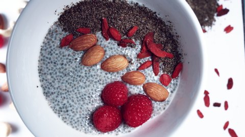 4k Hand Preparing Vegan Chia Pudding with Almond Milk, Berries and Seeds