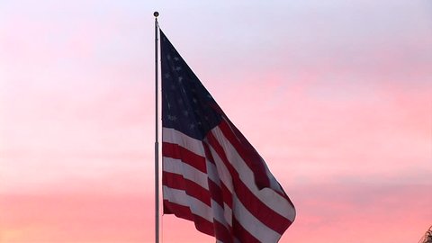 American flag blowing in the wind at sunset Stockvideo