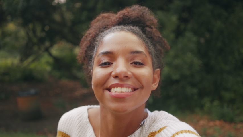 Smiling African Brazilian American young woman posing with her friends and making funny faces in front of camera whilst taking a selfie Royalty-Free Stock Footage #1036749647
