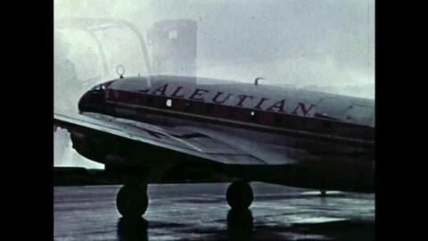 CIRCA 1950s - An Aleutian Airways plane and a C-123 transports cargo to Alaska.