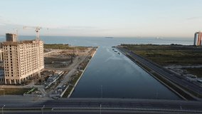 4K early summer morning aerial video of steel cables arched metal bridge over calm water channel, small lake near Baltic Sea Finnish Bay lagoon in Saint Petersburg, northern capital of Russia