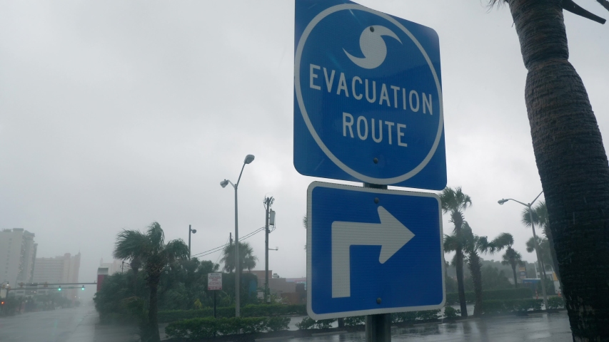 Myrtle Beach, South Carolina / USA - September 5, 2019: Hurricane Dorian Strong Winds Blow Evacuation Sign Royalty-Free Stock Footage #1036761824