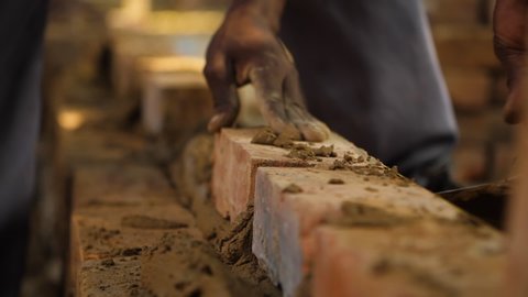 Tight shot of a brick wall being made.