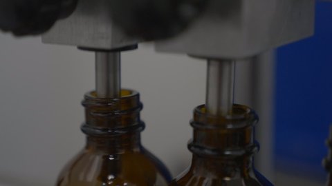 Glass supplement bottles in manufacturing plant 