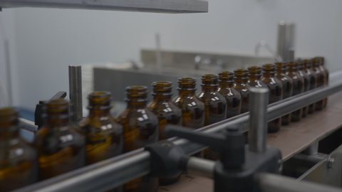 Glass supplement bottles in manufacturing plant 