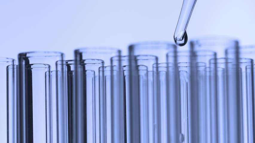 Closeup shot of scientist dripping liquid into test tube
