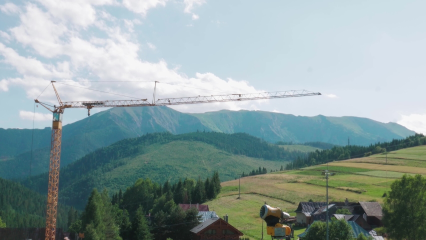 Bachledova / Slovakia - 07 04 2019: ZAKOPANE, POLAND - July 4, 2019: aerial drone shot of a crane in a valley, over the beautiful background of the mountains. | Shutterstock HD Video #1036795439
