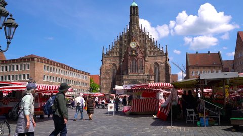 NUREMBERG, GERMANY - CIRCA MAY 2019: View on people as they visit the local market on a central square circa May 2019 in Nuremberg, Germany.