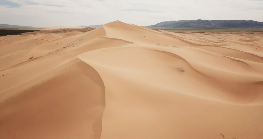 Aerial view of the Khongor Sand Dunes, Gobi Desert, Mongolia. | Shutterstock HD Video #1036799723