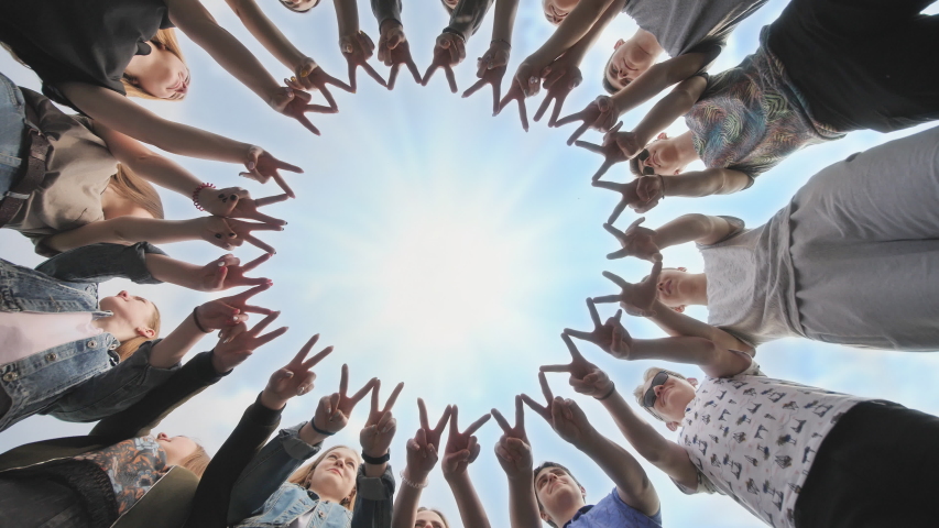 A group of friends make a circle out of their fingers. The concept of unity. Royalty-Free Stock Footage #1036799903