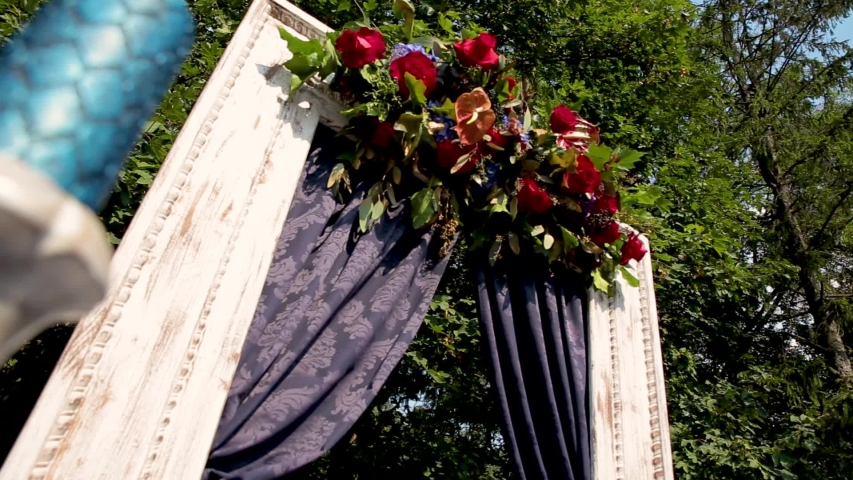 Wedding ceremony outside the restaurant. Chairs and blue walkway for brides and guests.
