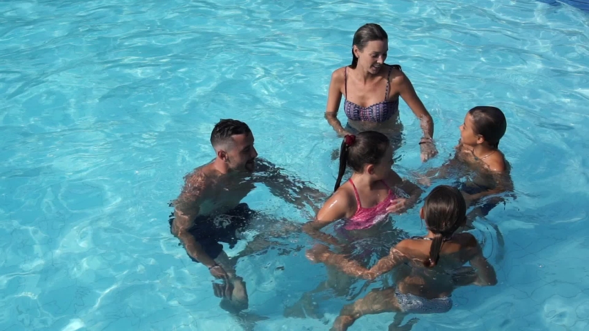 Family enjoying time at the swimming-pool | Shutterstock HD Video #1036815608