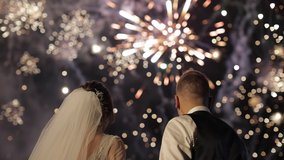 Couple in love watching fireworks. Fireworks on a black background. Silhouette of a couple on fireworks background. Newlyweds - Powered by Shutterstock - Get 15% off with code: PIKWIZARD15