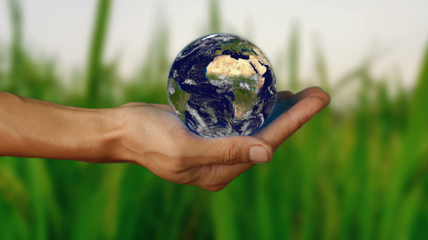 Female hand holding a realistic Earth. Holding the world in your hand. Rotation planet. Earth globe. World map design. Global sphere planet. Texture map courtesy of NASA.