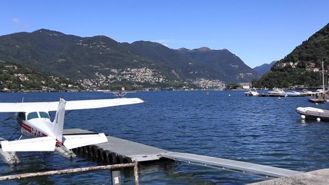 Floatplane landing on lake Como in Italy  during a sunny day