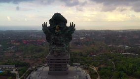 Bali's Most Iconic Landmark Hindu God Garuda Wisnu Kencana statue Bali, Indonesia. 4k Aerial view at sunset