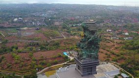 Bali's Most Iconic Landmark Hindu God Garuda Wisnu Kencana statue Bali, Indonesia. 4k Aerial view at sunset