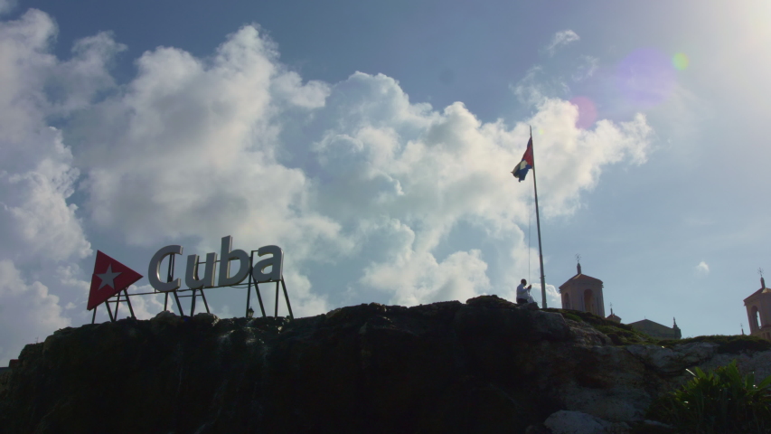 Cuba sign with cuban flag behind