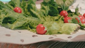 plate with fresh lettuce, cherry tomatoes and basil. fresh vegetables on plates. vegetable salad. 4k. 4k video. 60 fps