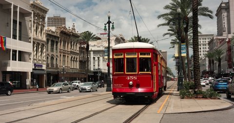 New Orleans, Louisiana - June 17, 2019: A historic red streetcar travels down the train tracks on Canal Street in New Orleans, Louisiana USA