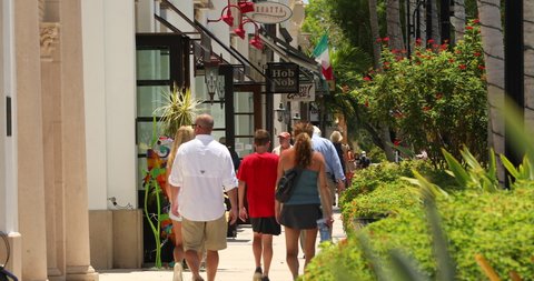Naples, Florida - June 14, 2019: Tourist walk and shop along the restaurants and luxury stores of 5th Avenue in downtown Naples Florida USA
