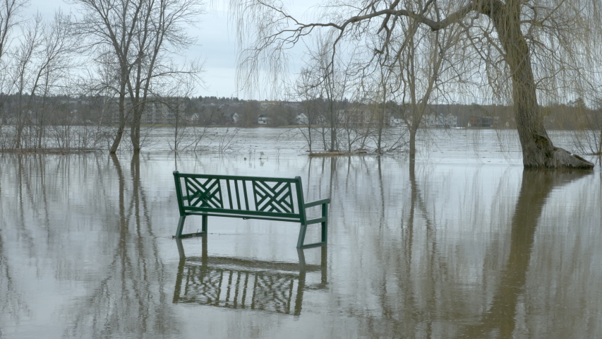 Flooded park after heavy rain with bench Royalty-Free Stock Footage #1036833392