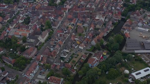 Aerial view of the old town of Kenzingen in Germany on a cloudy day in the afternoon. Very wide view with round pan to the right