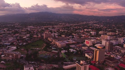 An aerial overview of Kingston, Jamaica. Taken during sunset from above the Pagasus Hotel. Panning from right to left.