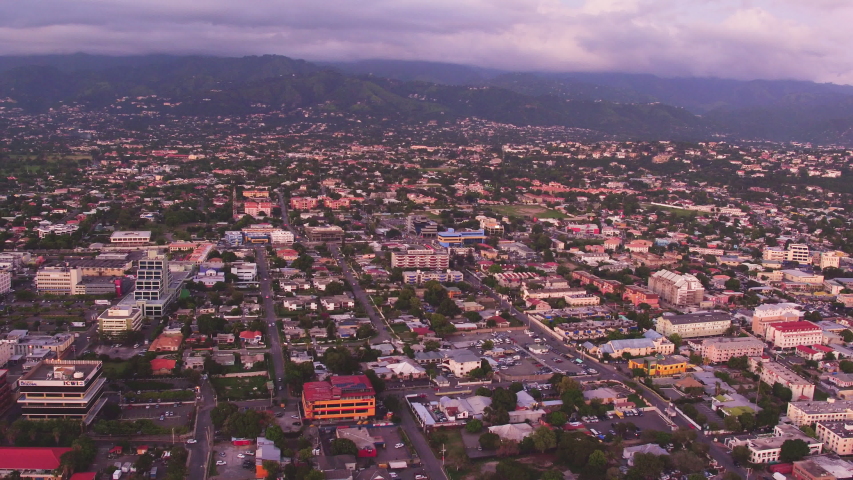 An aerial overview of Kingston, Jamaica. Taken during sunset from above the Pagasus Hotel. Panning from right to left.
