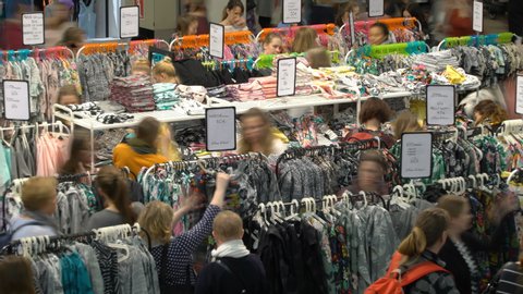 HELSINKI, FINLAND - APRIL 13, 2019: Big sale at the outlet mall. A lot of women choose clothes during the final clearance sale. Time lapse