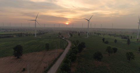 Aerial view of Wind turbines Energy Production- 4k aerial shot on sunset. 4k drone footage turbines at sunrise with clouds