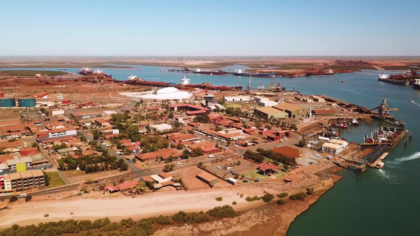 Circling aerial shot of working port town, Port Hedland, Western Australia