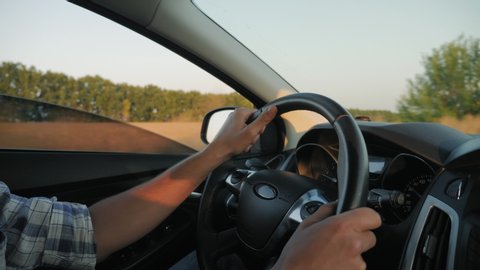 Closeup of man hands on steering wheel driving car, slow motion 4k video
