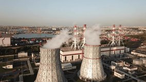 4K summer afternoon aerial drone video of South-Western thermal power station, electricity producing plant, huge cooling water towers, located on outskirts of St.-Petersburg, Leningrad Region, Russia