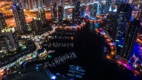Dubai Marina & Yacht club at Jumeirah Beach in Dubai, United Arab Emirates time lapse at night zoom out