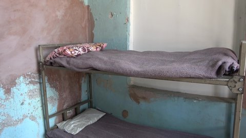 Ankara, Turkey - 2nd of August 2019: 4K The prison museum - Tilt down Two tier bed in a corner of prison sell
