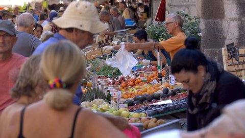 Annecy, France - July 2019 : Famous Annecy market, with farmers selling regional products to tourists, typical market of France