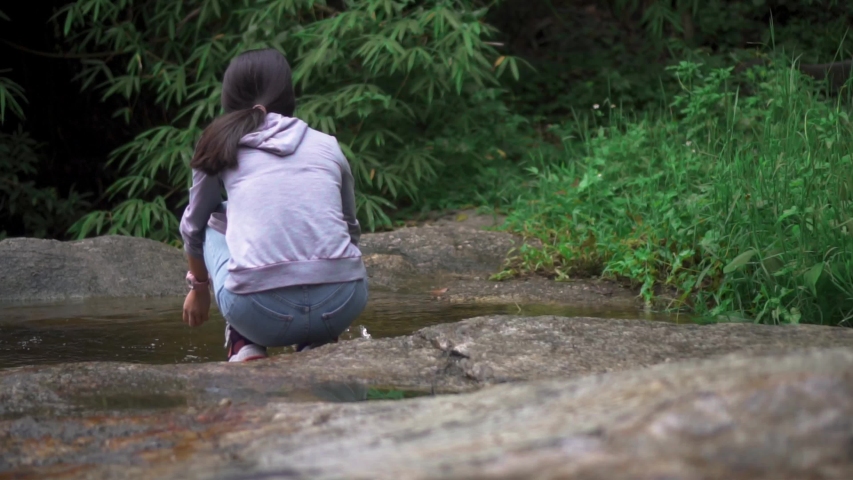 A girl playing with water in slowmotion.