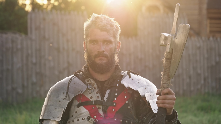 Portrait of medieval knight in armor and hammer in the hands. Close-up
