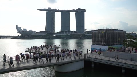 MARINA BAY ,SINGAPORE - March 10, 2019: Timelapse early morning of Merlion Statue Renovation Landmark Singapore country with sun rise front of Marina Bay Sands Resort Hotel and Many travelers walking.