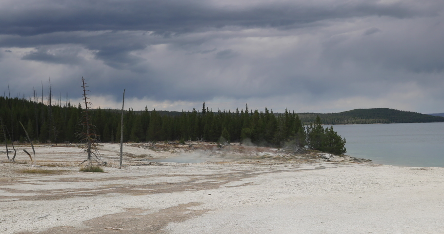 Yellowstone Lake West Thumb Geyser Basin to water. Geyser Yellowstone National Park in Wyoming, United States. Highly predictable geothermal ecosystem feature. Caldera, supervolcano.