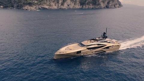 Stunning drone shot of luxurious golden yacht 