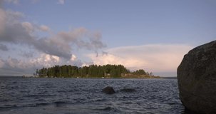 4K summer morning high quality video of Santalahti Baltic Sea Finnish Bay lagoon, pine tree forest beach with red granite boulders, lone island beach near Kotka, Finland Suomi, northern Europe