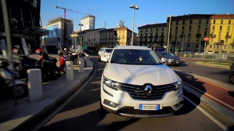 Milan Italy September 11, 2019. Cars moving around the city in the daytime. City life. White cars and taxis. Atmosphere before Milan Fashion Week. City traffic. Autumn trees. Crossover Renault
