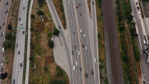 Aerial establishing shot of highway traffic on an overcast day. Cinematic 4K footage.