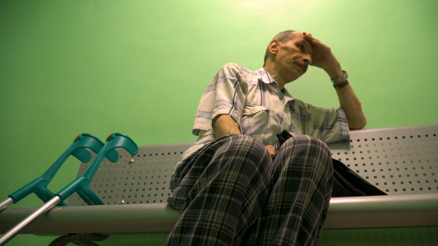 Rack focus shot of a man having pain before visiting a doctor 