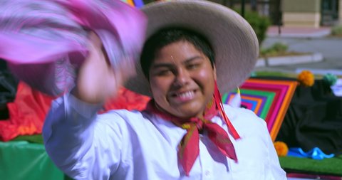 Young hispanic man in traditional dress dancing at Mexican Independence Day parade in Los Angeles, California, 4k