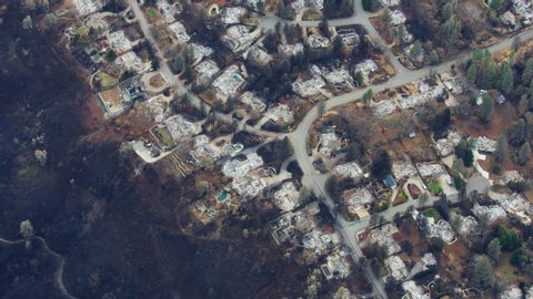 Aerial overhead view of destructive forest wildfire which has laid waste to an entire town a community destroyed property and lives lost Paradise California RED WEAPON