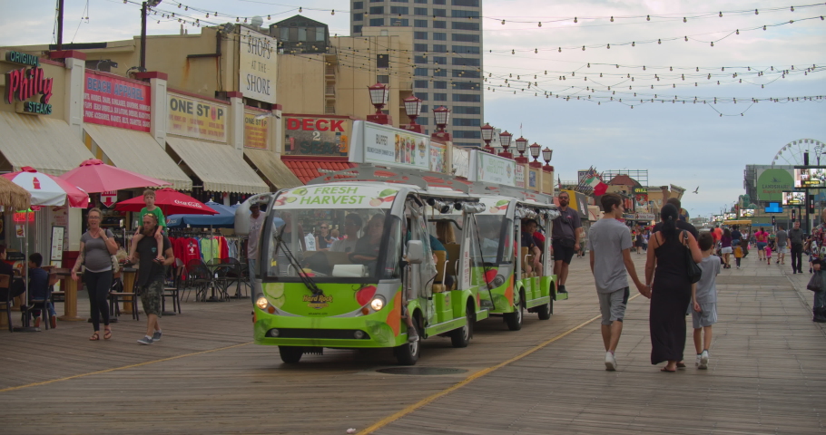 Atlantic City, New Jersey / United States - August 28 2019: Electric tram transports visitors along boardwalk.